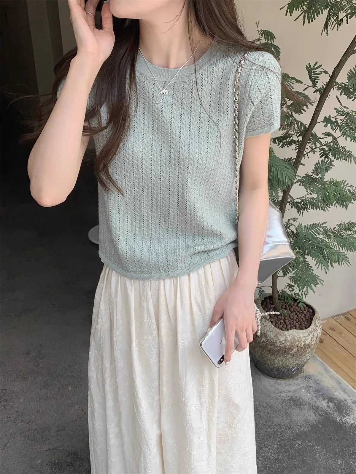 A hollowed-out round-neck ice silk knitted T-shirt for women in summer, a loose short-sleeved and slimming top, is thin