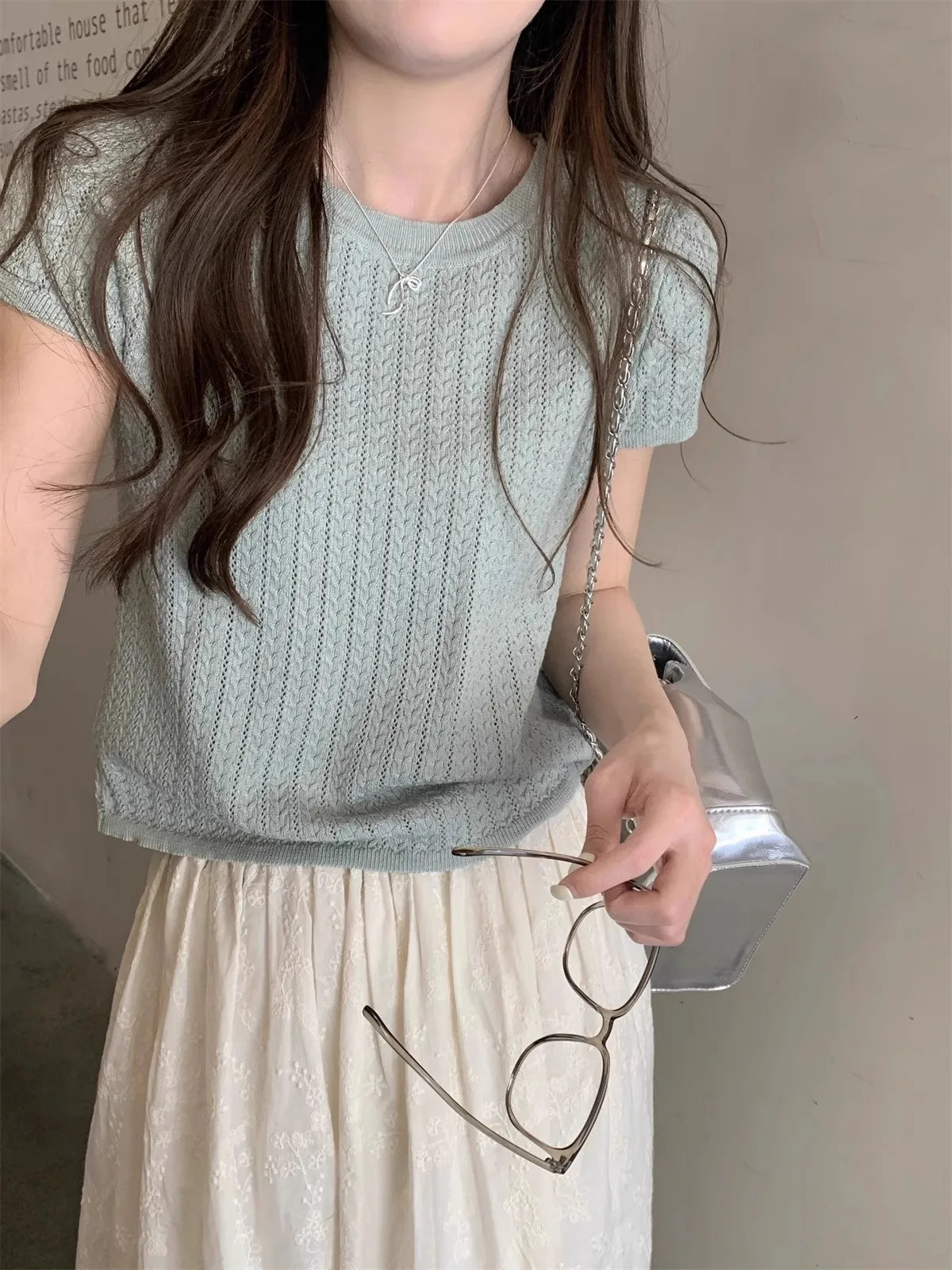 A hollowed-out round-neck ice silk knitted T-shirt for women in summer, a loose short-sleeved and slimming top, is thin