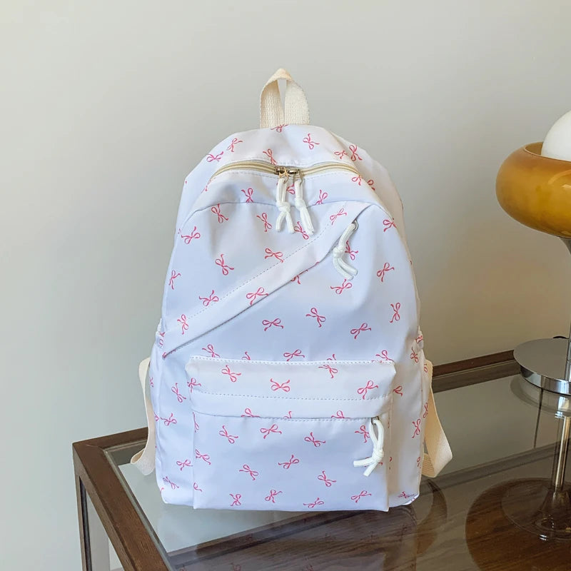 Women's Bow Print Backpack with Front Zipper Pocket for School Outfits