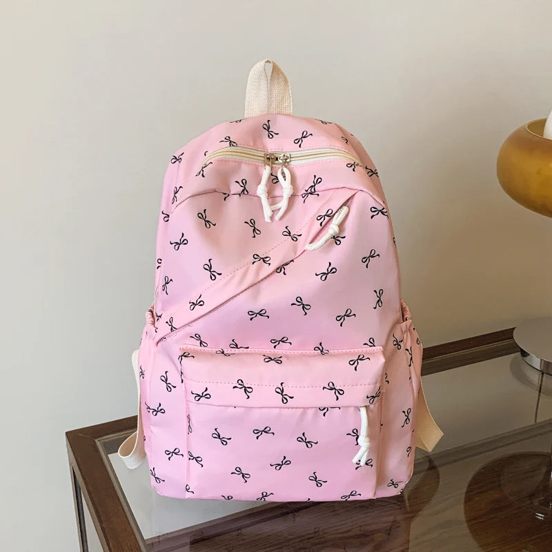 Women's Bow Print Backpack with Front Zipper Pocket for School Outfits