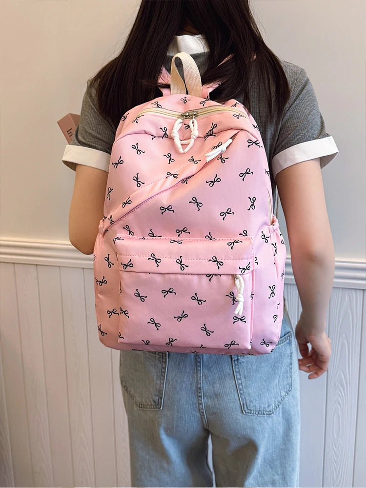 Women's Bow Print Backpack with Front Zipper Pocket for School Outfits