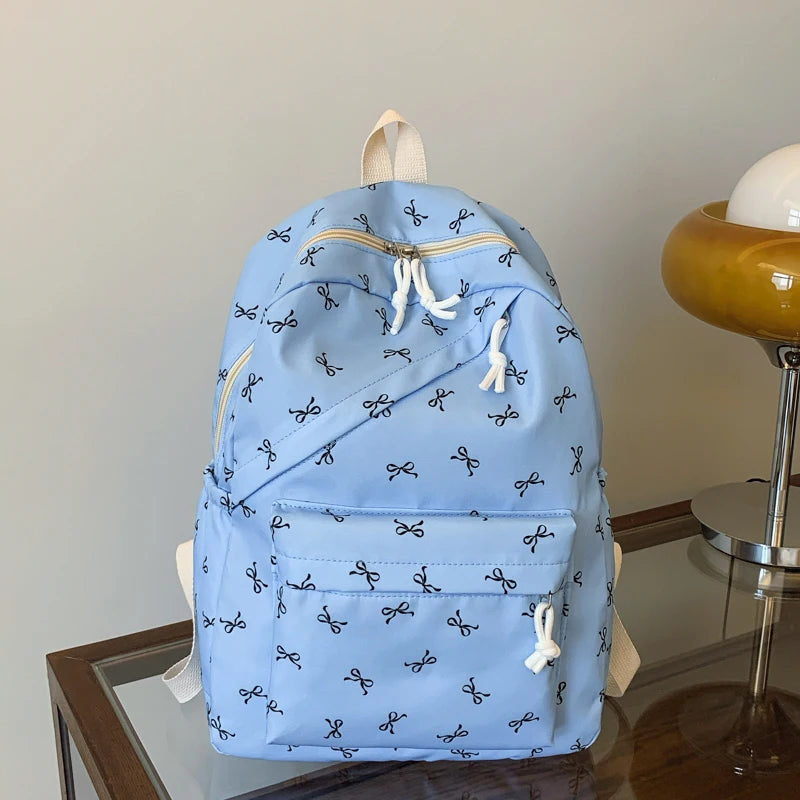 Women's Bow Print Backpack with Front Zipper Pocket for School Outfits