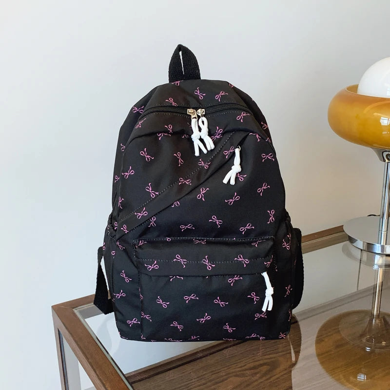 Women's Bow Print Backpack with Front Zipper Pocket for School Outfits